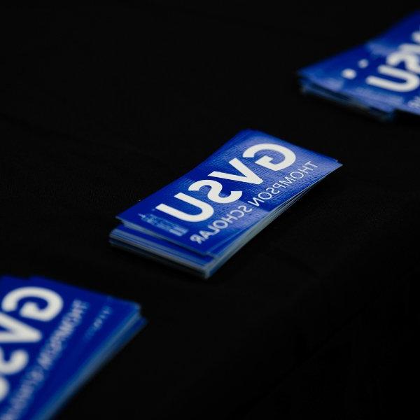 bookmarks on a black table cloth say GVSU Thompson Scholars