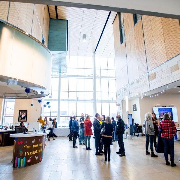 people mingle in the atrium level of the Mary Idema Pew Library